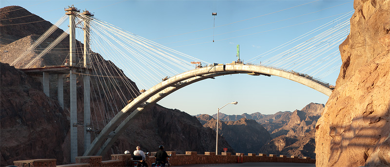 20090801 063658 9909
Almost there.  A couple of riders watch as The final section of the arch to the Highway 93 Hoover Dam Bypass is installed.  The bridge is slated to be completed in 2010 after 5 years of construction.  This 1060 foot long twin arch sits 900 feet above the Colorado River.  The bridge itself will span nearly 2000 feet.
